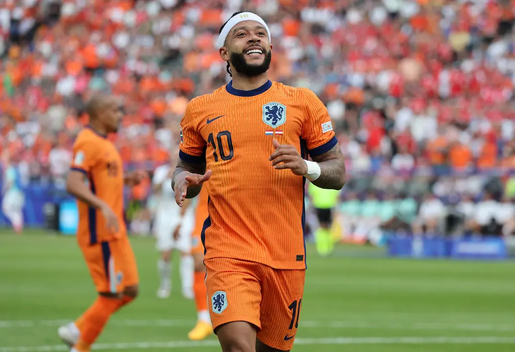 Memphis Depay sorri em campo com a camisa alaranjada da Seleção Holandesa durante a Copa do Mundo 2026